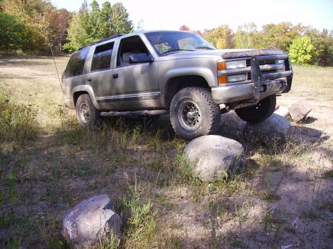 2000 Chevrolet Tahoe - This Chevrolet Tahoe is navigating a rocky trail, demonstrating its off-road capability.