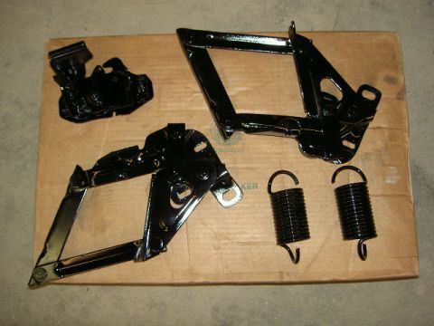1967 Ford Ranchero - Hood hinges and springs laid out on a cardboard box.