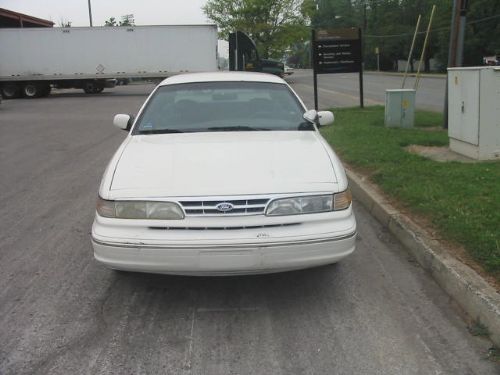 White Ford Crown Victoria, front view, parked on asphalt