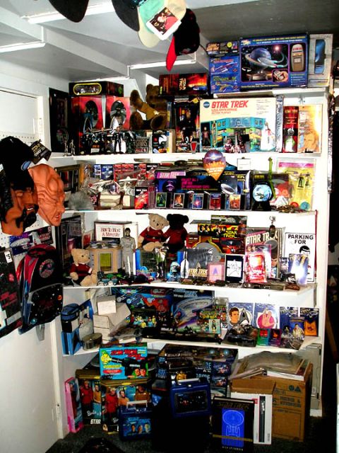 1966 Pontiac Fiero - A collection of Star Trek merchandise, including action figures, model ships, and boxed playsets, displayed on shelves.