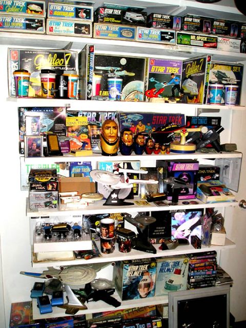 1966 Pontiac Fiero - A collection of Star Trek merchandise is neatly organized on shelves.