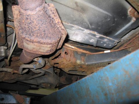 1991 Ford LTD Crown Victoria - Significant rust is visible on the undercarriage components of the vehicle.