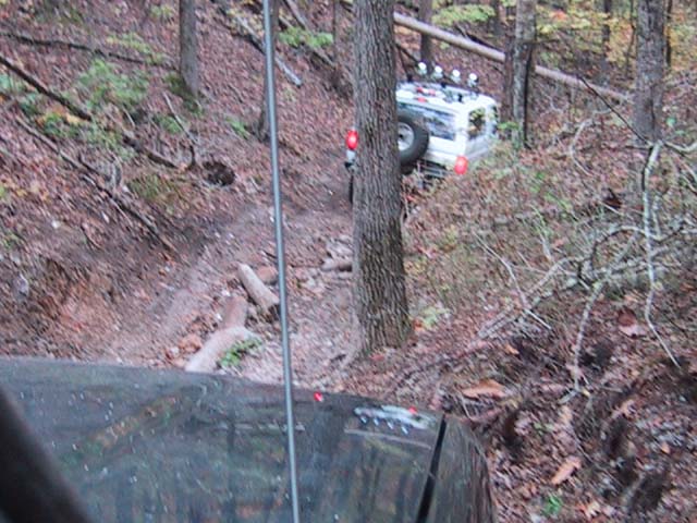 White 1995 Ford Bronco on a steep, wooded trail