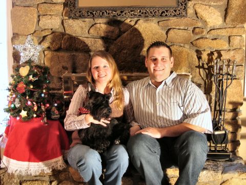 1985 Ford LTD Crown Victoria - A couple and their dog pose for a holiday photo in front of a stone fireplace with a decorated Christmas tree.