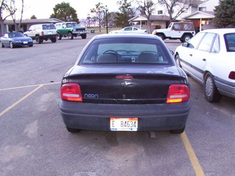 2003 Ford Ranger - Black sedan parked in a lot with other vehicles visible in the background.