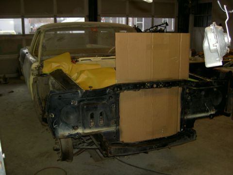 1967 Ford Ranchero - A 1967 Ford Ranchero is seen in a garage with its front end disassembled for restoration, with yellow protective covers in the engine bay.