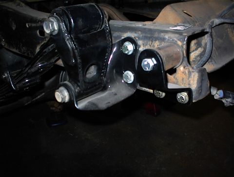 1984 Ford Bronco - Vehicle frame components, including leaf springs and aftermarket brackets, are shown in this close-up view.