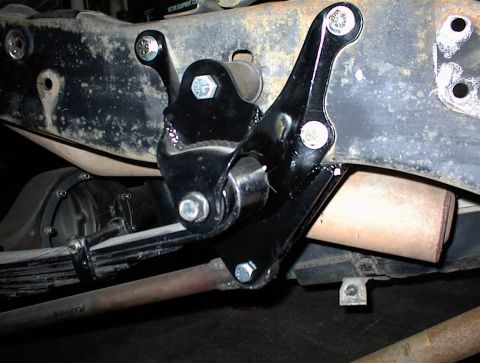 1984 Ford Bronco - Close-up of aftermarket suspension components on a vehicle's undercarriage.