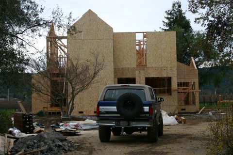 1996 Ford Bronco - A 1996 Ford Bronco is parked at a construction site with a house being built in the background.