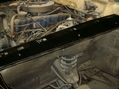 1967 Ford Ranchero - Close-up view of a vehicle's engine bay, focusing on a newly installed black trim piece.