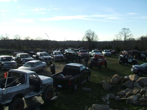1995 Ford Bronco - A modified 1995 Ford Bronco is seen in a field with numerous other trucks and SUVs.