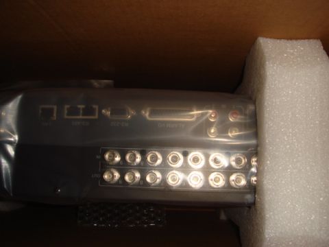 1996 Ford Bronco - Rear of a security DVR or video device in foam packaging, showing LAN, RS-232/485, alarm I/O and rows of BNC connectors.