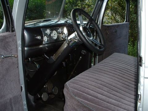 1946 Chevrolet C/K Pickup - The interior of a 1946 Chevrolet C/K Pickup features a custom dashboard with updated gauges and a modern steering wheel.