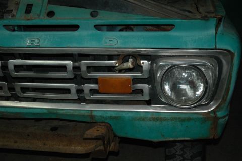1963 Ford F-250 - The front grille of a turquoise Ford truck, a padlock and amber turn signal.