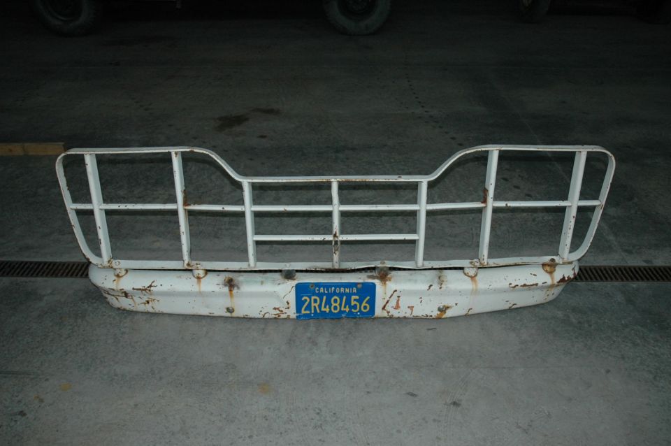 White 1963 Ford F-250 grille guard and bumper assembly with California license plate 2R48456, showing rust and wear