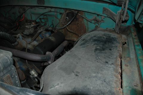 1963 Ford F-250 - Close-up view of the engine compartment, highlighting the condition of various components and the surrounding metalwork.