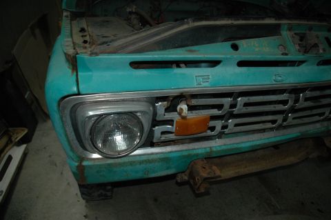 1963 Ford F-250 - Close-up of a vintage Ford F-Series truck's front end, showing the grille and headlight assembly.