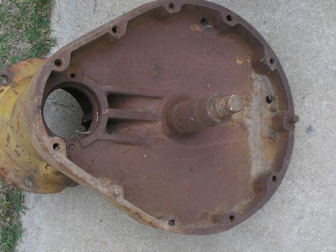 1990 Ford Bronco - This is a rusted metal part with a shaft, likely a component from machinery or a vehicle.