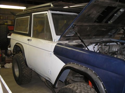 1966 Ford Bronco - This 1966 Ford Bronco is undergoing some work, with its hood open to reveal the engine bay.