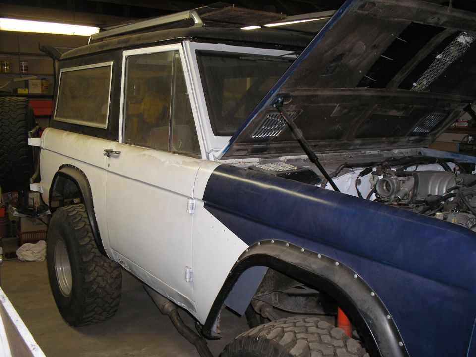 1966 Ford Bronco, white and blue, hood open, showing engine