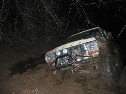 1992 Ford Mustang - This truck appears to be stuck in the mud, with its front end angled downwards.
