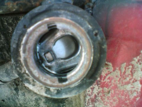 1985 Ford F-150 - The opening for the fuel filler neck, showing wear and dirt around the seal.