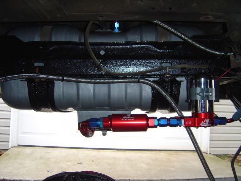 1978 Ford Bronco - Aftermarket fuel filter and pump assembly installed on a vehicle's undercarriage.