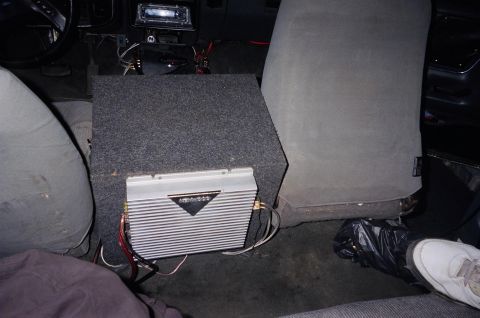 1989 Ford Bronco - Aftermarket audio equipment, including a subwoofer and amplifier, is installed in the interior of a vehicle.