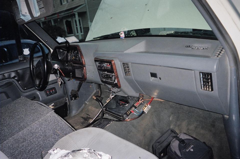 1989 Ford Bronco interior showing dashboard, steering wheel, and aftermarket stereo installation