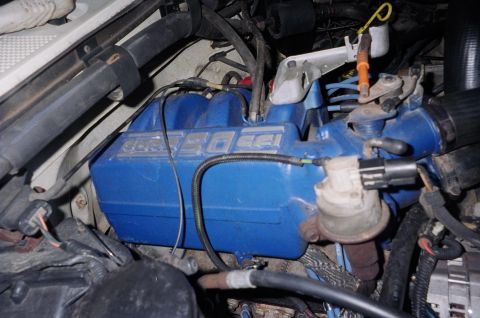 1989 Ford Bronco - Close-up of a blue engine intake manifold with '5.0 EFI' text visible.