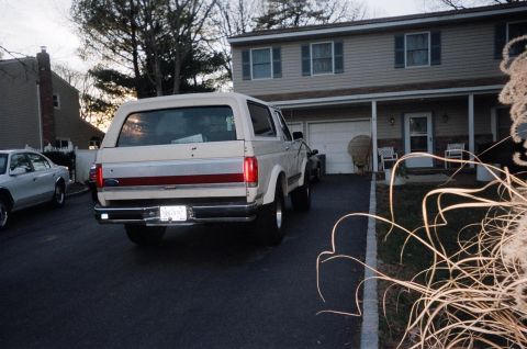 1989 Ford Bronco - Rear view of a 1989 Ford Bronco parked in a suburban driveway.