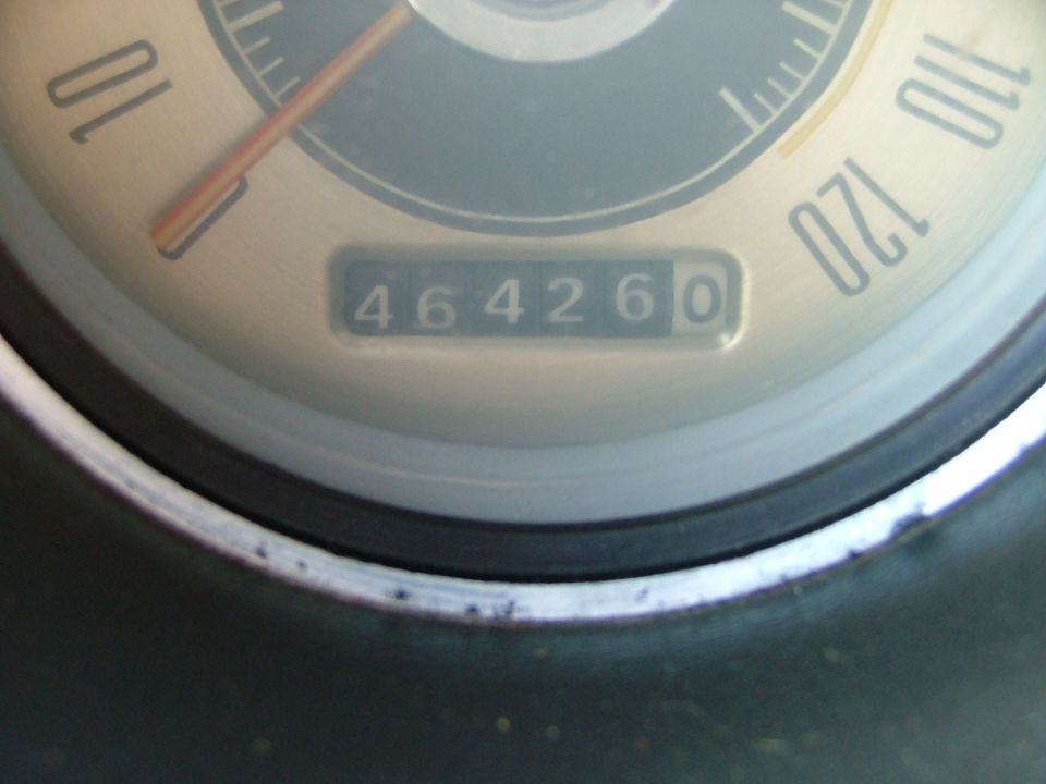 Close-up of a vintage speedometer and odometer reading about 46,426 miles
