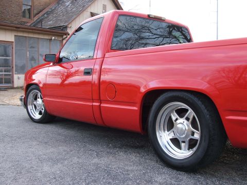 1996 Ford Probe - A red pickup truck is shown from the side, parked in front of a residential building.