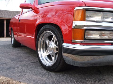 1996 Ford Probe - A red pickup truck is shown from the front quarter, highlighting its chrome wheels and bumper.