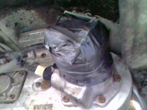 1976 GMC C/K Pickup - A close-up view of a vehicle component, possibly part of the transmission, covered with a black plastic bag.