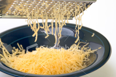 1991 Ford Bronco - Grating cheese into a bowl. The image shows shredded cheese falling from a grater.