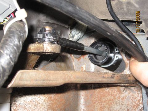 1994 Ford Bronco - Close-up view of a mechanical linkage and cable assembly within a vehicle's interior.