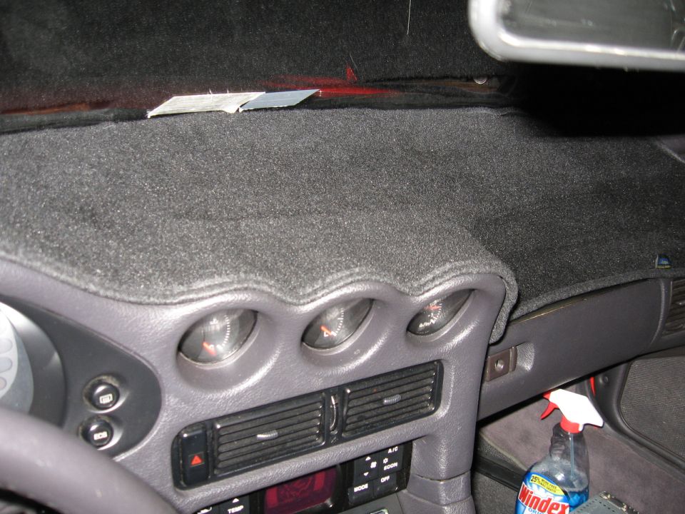 dashboard with three gauges, air vents, and a Windex bottle
