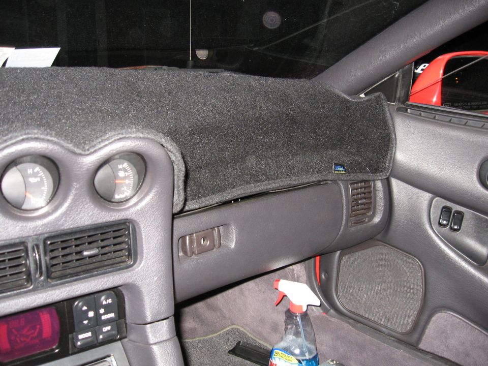 1991 Mitsubishi 3000GT interior with dashboard cover, gauges, and spray bottle