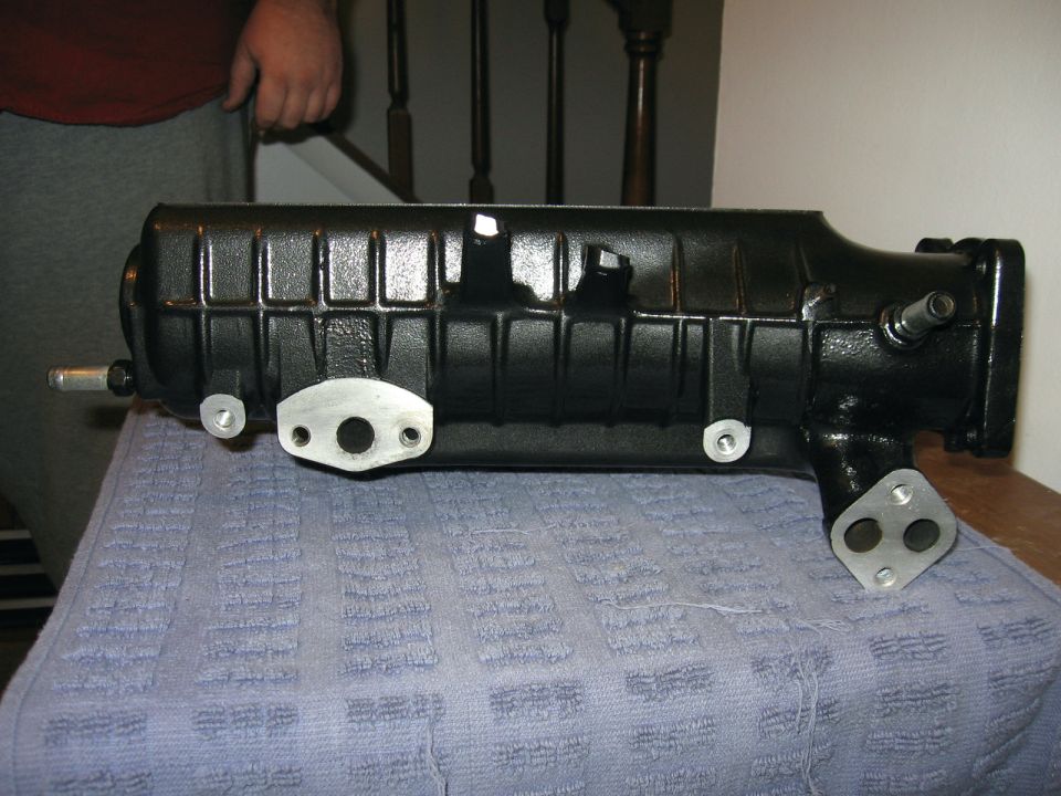 black intake manifold with silver mounting plates