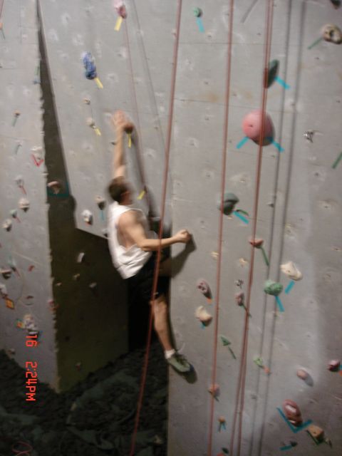 1979 Ford Bronco - Person climbing an indoor wall with colorful holds and ropes.