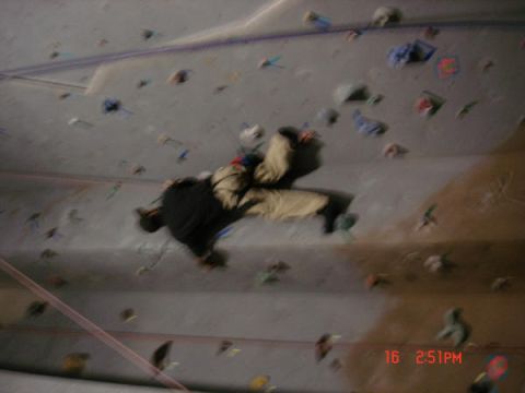 1979 Ford Bronco - A climber ascends an indoor wall, navigating colorful holds.