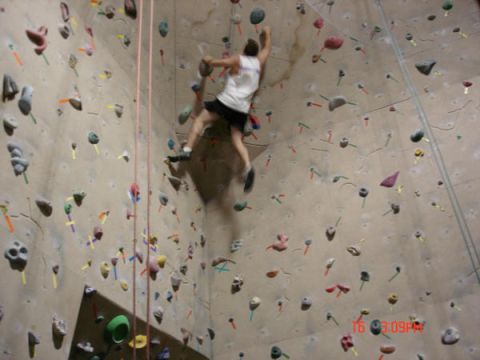 1979 Ford Bronco - A climber ascends a textured indoor wall dotted with numerous colorful hand and foot holds.