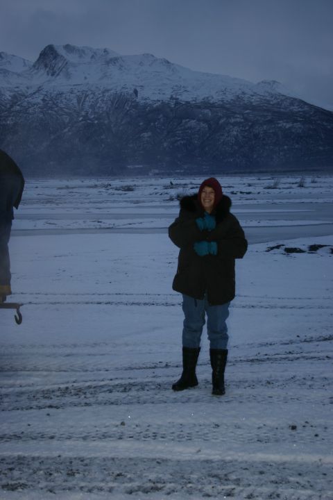2003 Jeep TJ - A person stands in a snowy, mountainous landscape, likely Alaska, during winter.