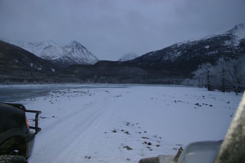 2003 Jeep TJ - Winter scene with mountains and two vehicles in the snow.