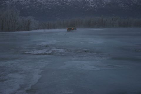 2003 Jeep TJ - A 2003 Jeep Wrangler navigates across a frozen landscape under a cloudy sky.