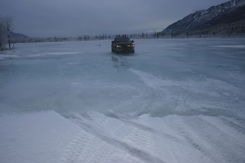 2003 Jeep TJ - A lone truck navigates across a vast, frozen expanse under a cloudy sky.