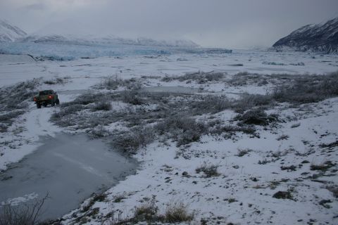 2003 Jeep TJ - A Jeep Wrangler navigates a snowy landscape with a glacier visible in the distance.