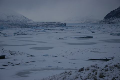 2003 Jeep TJ - A vast, frozen landscape stretches out, dominated by a distant glacier under a muted, overcast sky.