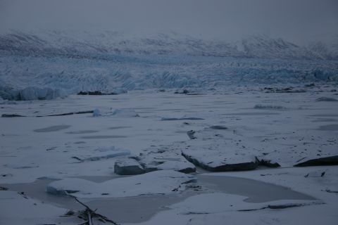 2003 Jeep TJ - A vast expanse of ice and snow stretches towards a massive glacier under an overcast sky.